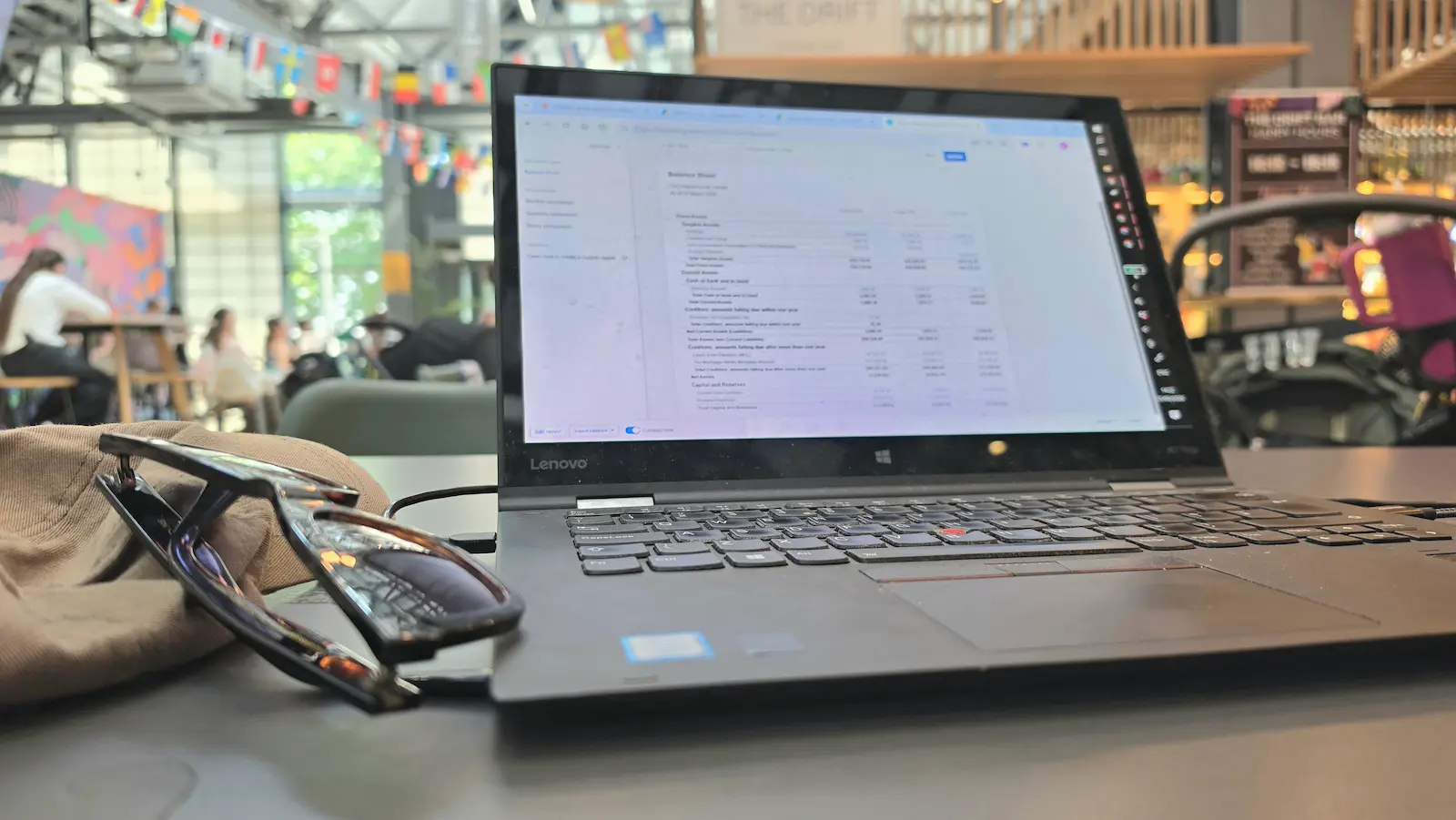 Laptop showing Xero balance sheet in a café - reviewing BTL company carried forward losses
