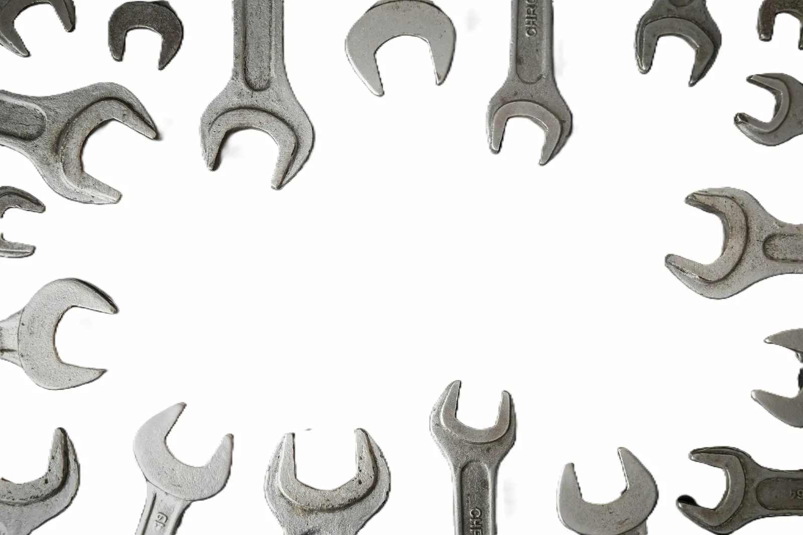 Wrenches arranged in a circle on a light background - productivity tool adoption and knowing when to pick up a new tool