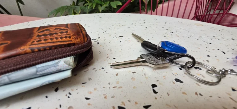 Notebook and phone on a desk - landlord coordinating a tenant repair request without a letting agent