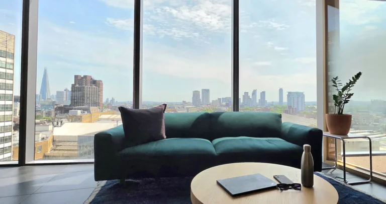 London skyline view from a workspace with notebook on table - managing accounts across multiple businesses with Xero
